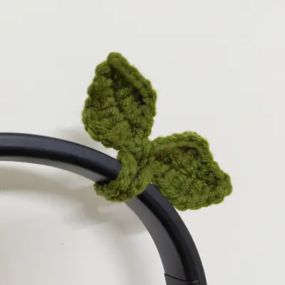 Olive green crochet leaf bow fixed to a headband